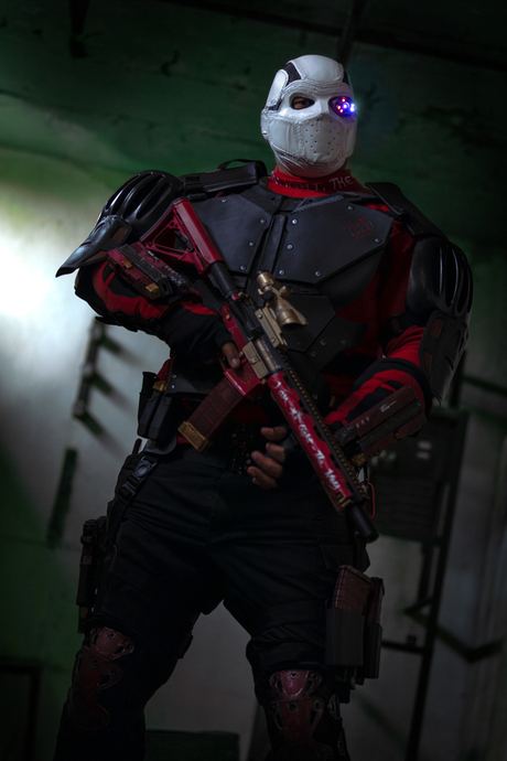 Character photo of a masked figure with a rifle in green light