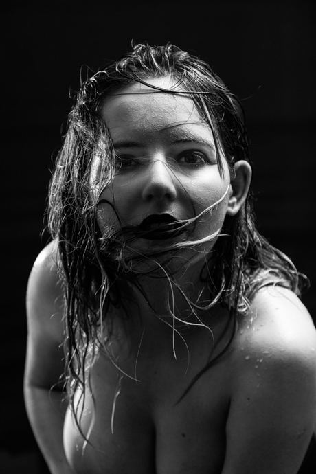 Low-key black and white portrait with wet hair