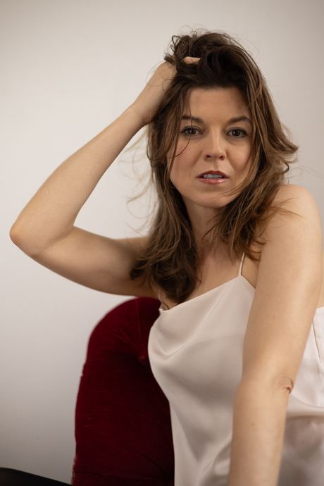 Portrait of a woman with a hand in her hair in warm light